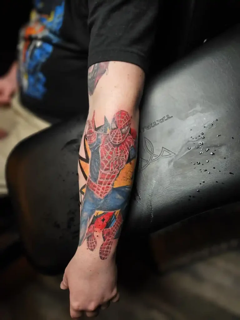 Color tattoo sleeve of a masked superhero in a web-covered comic book style design