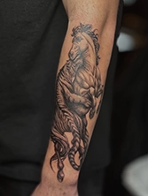 Small minimalist fine line tattoo on wrist with delicate single-needle strokes
