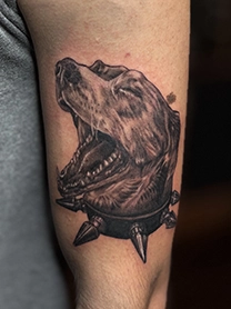 Black and grey animal tattoo on calf with realistic fur texture shading