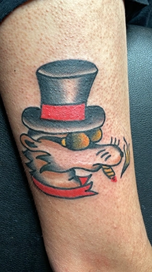 Large scale color tattoo on thigh combining bold outlines and shading