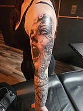 Small black and grey tattoo on ankle with clean simple linework