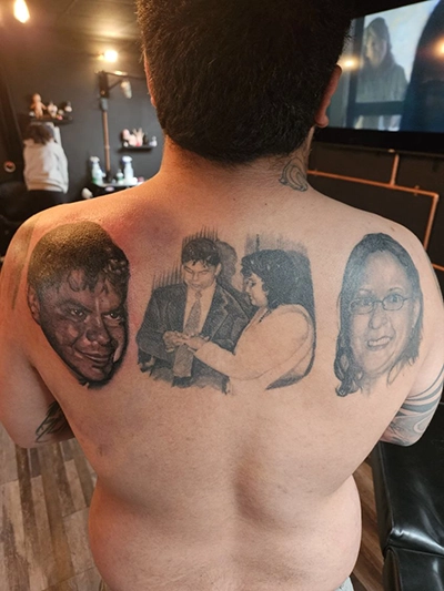 Large scale custom tattoo covering torso with intricate layered color detail