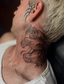 Black and grey tribal style neck tattoo